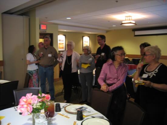 Alumni and family watch a slide show and reminisce